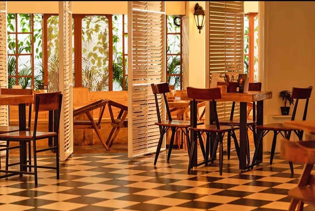 Checkered-floor dining area by shuttered windows at Terra Cafe & Bistro